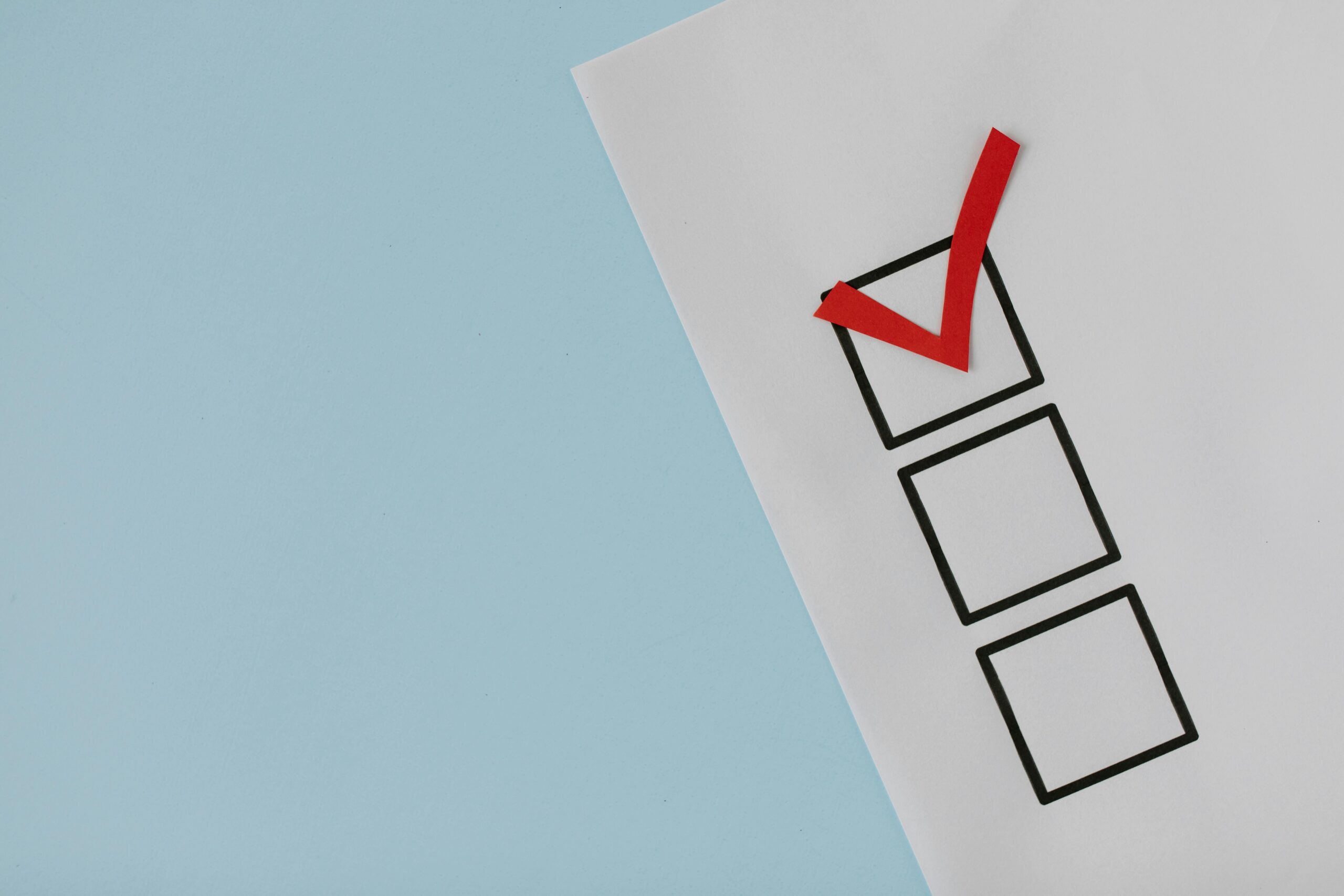 pexels-photo-8850706-8850706 A simple white paper checklist with one red checkmark, ideal for concepts like completion or approval.