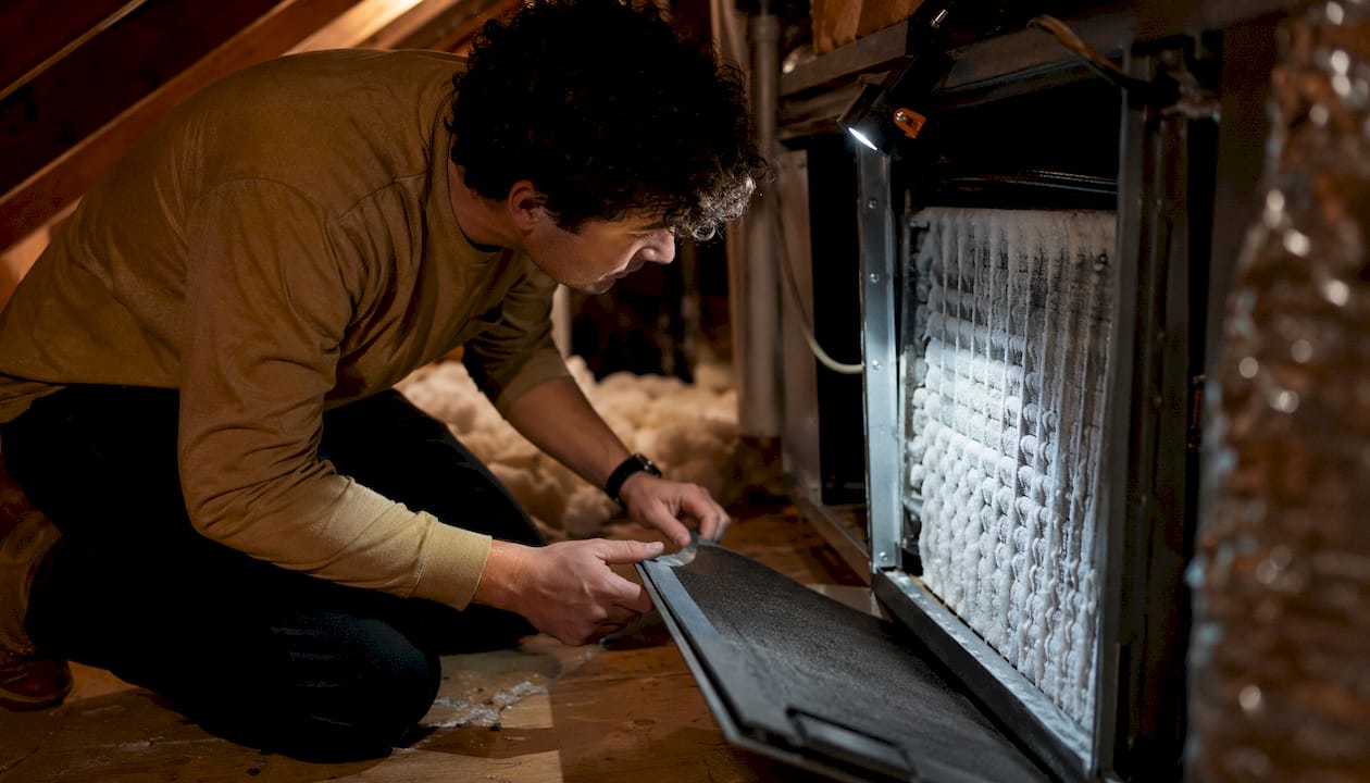 AC Unit Frozen? Diagnose, Thaw, and Fix It Fast ac unit frozen diagnose fix ac unit frozen diagnose fix 1784975215028 Homeowner examining frozen evaporator coil inside closet Homeowner examining frozen evaporator coil inside closet